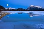 Situated near the town of Banff, 2nd Vermilion Lake is partially frozen during the winter months but still provides enough open space for a reflection of the wonderful winter scenery and full moon at dusk.