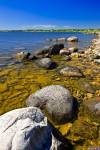 The waters of Lake Winnipeg and the shoreline of Hecla Island are the year-round playground of locals and tourists alike. This rocky shore is situated in the Hecla/Grindstone Provincial Park in Manitoaba, Canada.