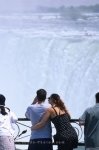 A young couple looking at the Niagara Falls, Ontario, Canada, North America.