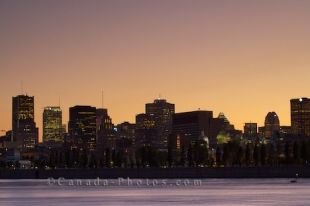 The beautiful colors at sunset reflect off the St. Lawrence River and span the sky over the downtown core of Montreal City in Quebec, making the skyline picturesque from the island of Ile Sainte-Helene.